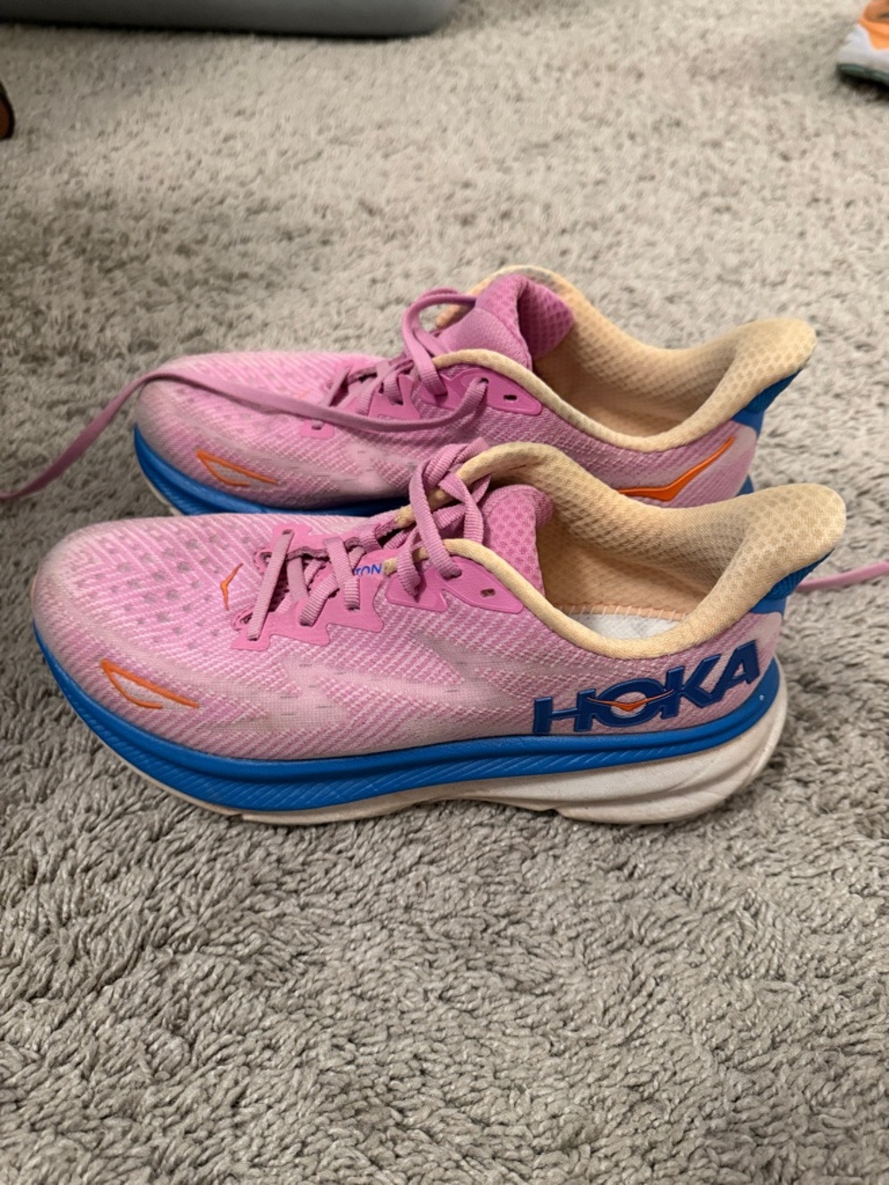 Hoka Pink Running Sneakers with Blue Soles and Orange Accents. Clifton 9s
